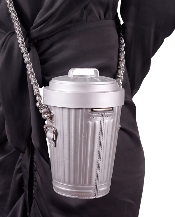 Moschino Trash Can chain shoulder bag in grey on model, worn crossbody on a chunky silver chain over a black dress