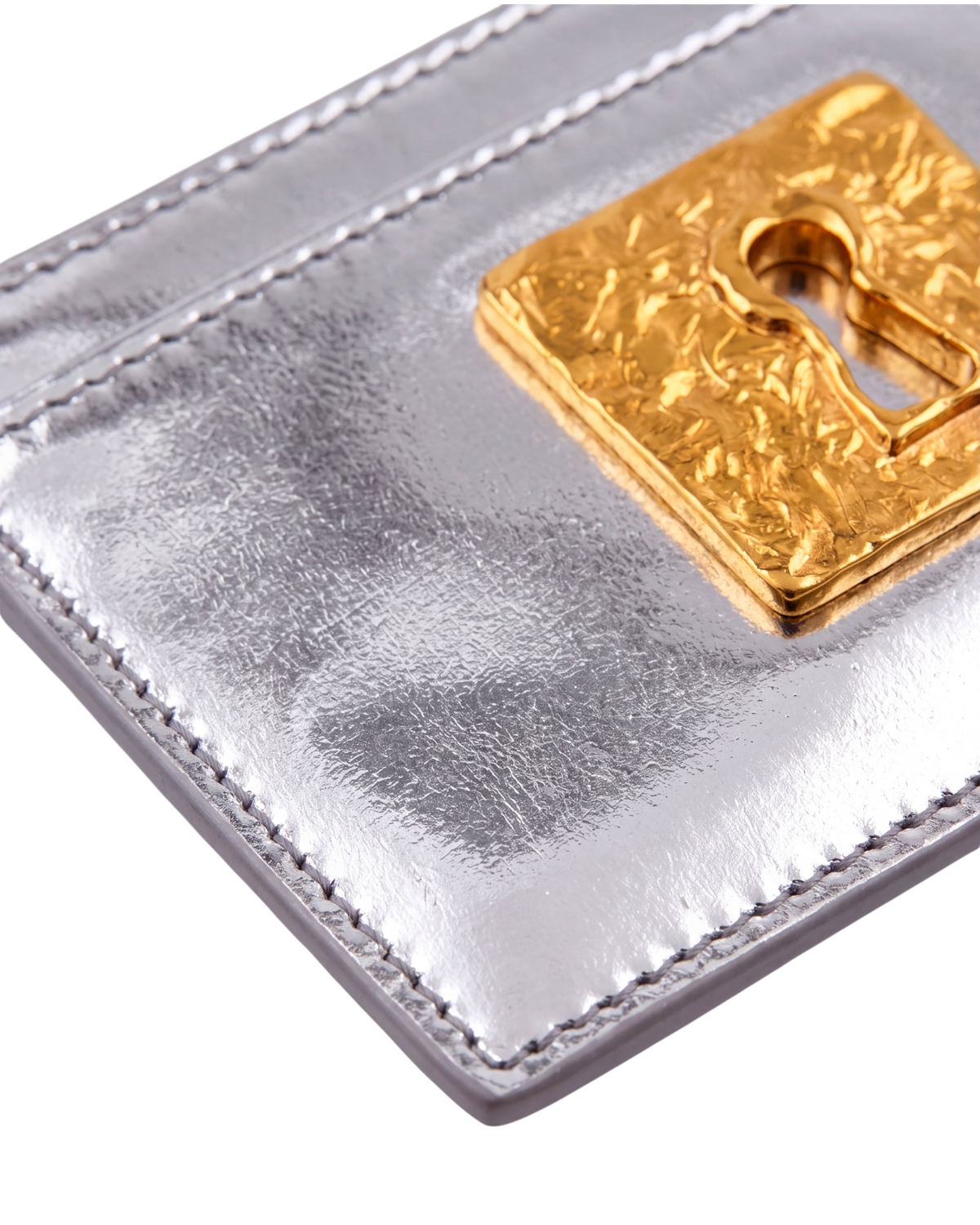 Schiaparelli Keyhole card holder in silver, detail close-up of the textured gold keyhole hardware and edge stitching