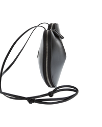 Alaïa Le Coeur leather shoulder bag in black, side view showing the slim profile and wraparound silver zipper