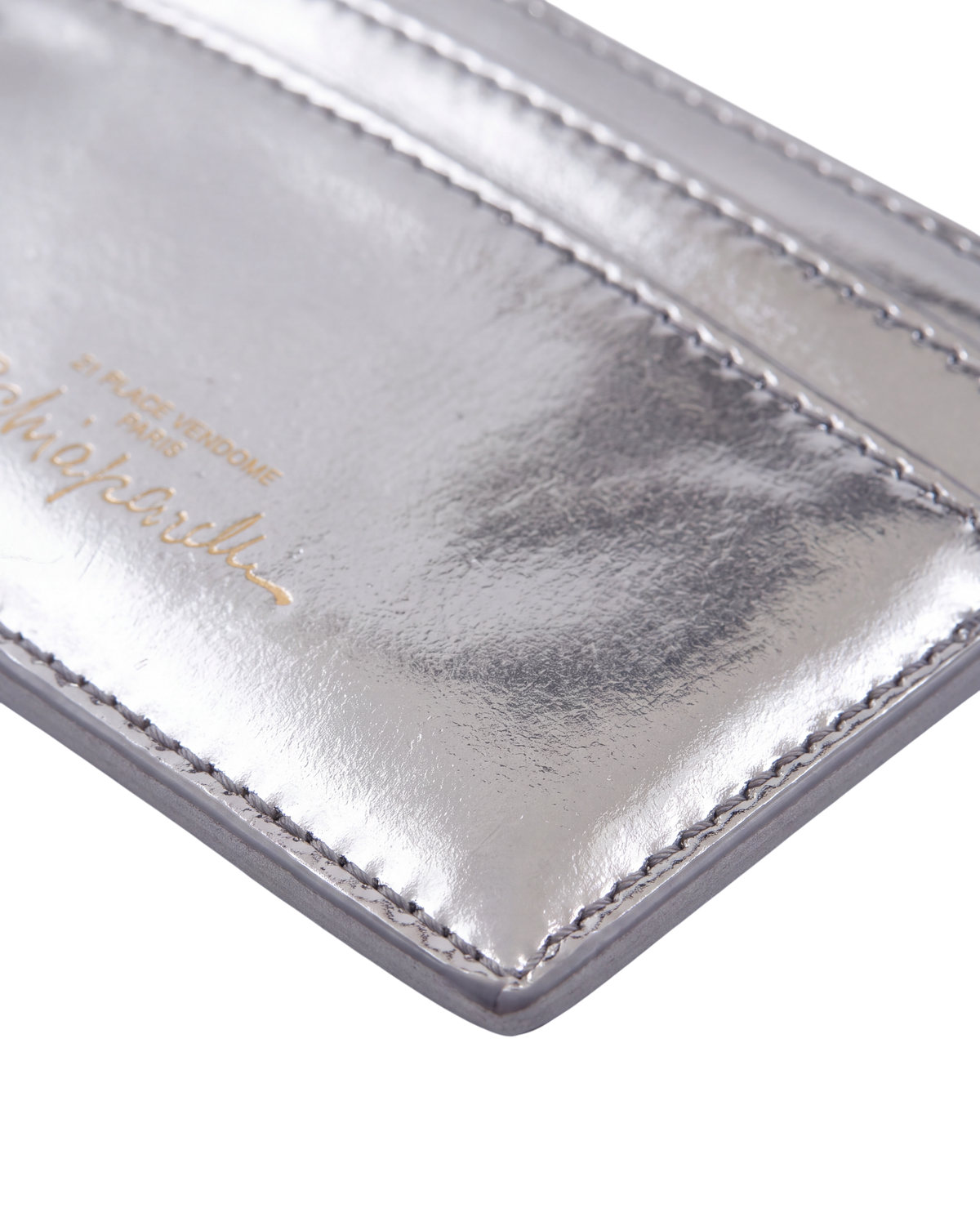 Schiaparelli Keyhole card holder in silver, detail close-up of the gold-stamped Schiaparelli signature on the back