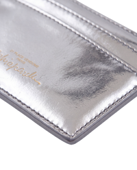 Schiaparelli Keyhole card holder in silver, detail close-up of the gold-stamped Schiaparelli signature on the back