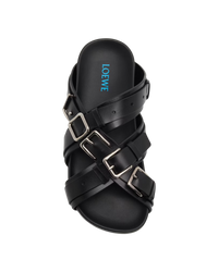 Loewe Type Fussbett sandal in black, top-down view of a single sandal with four silver buckles and blue Loewe logo