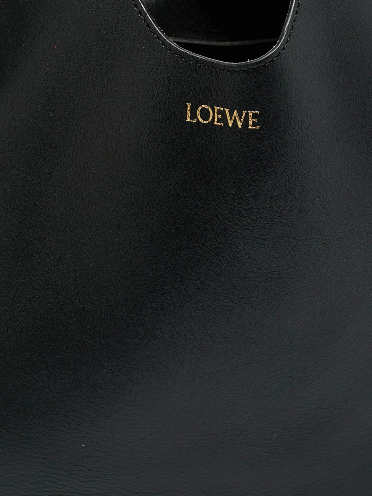 Loewe Paseo knotted leather tote in black, detail close-up of the smooth leather and gold-foil Loewe logo stamp