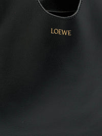 Loewe Paseo knotted leather tote in black, detail close-up of the smooth leather and gold-foil Loewe logo stamp