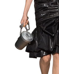 Moschino Trash Can chain shoulder bag in grey, on-model close-up of the ribbed canister body hanging from chunky chain