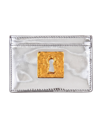Schiaparelli Keyhole card holder in silver, front flat view of the mirrored leather with a hammered gold keyhole plaque