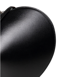 Alaïa Le Coeur leather shoulder bag in black, detail close-up of the glossy textured leather and stitched edge