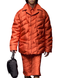 Fendi reversible quilted puffer blouson in bitter orange on model, runway front view with diagonal quilting