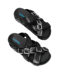 Loewe Type Fussbett sandal in black, top-down view of the pair with silver buckles and blue Loewe logo on the footbeds