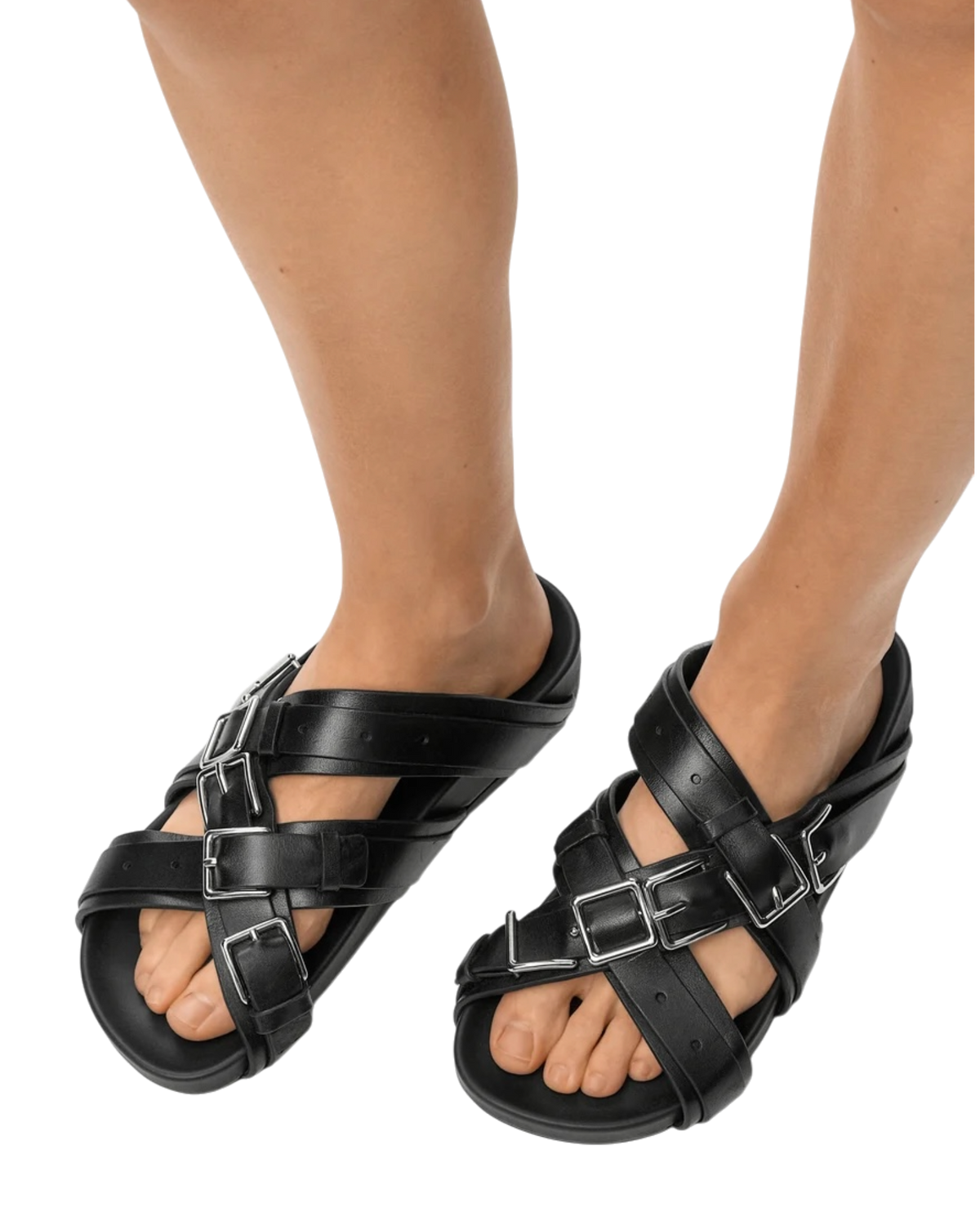 Loewe Type Fussbett sandal in black on model, front view of the pair with crisscross leather straps and silver buckles