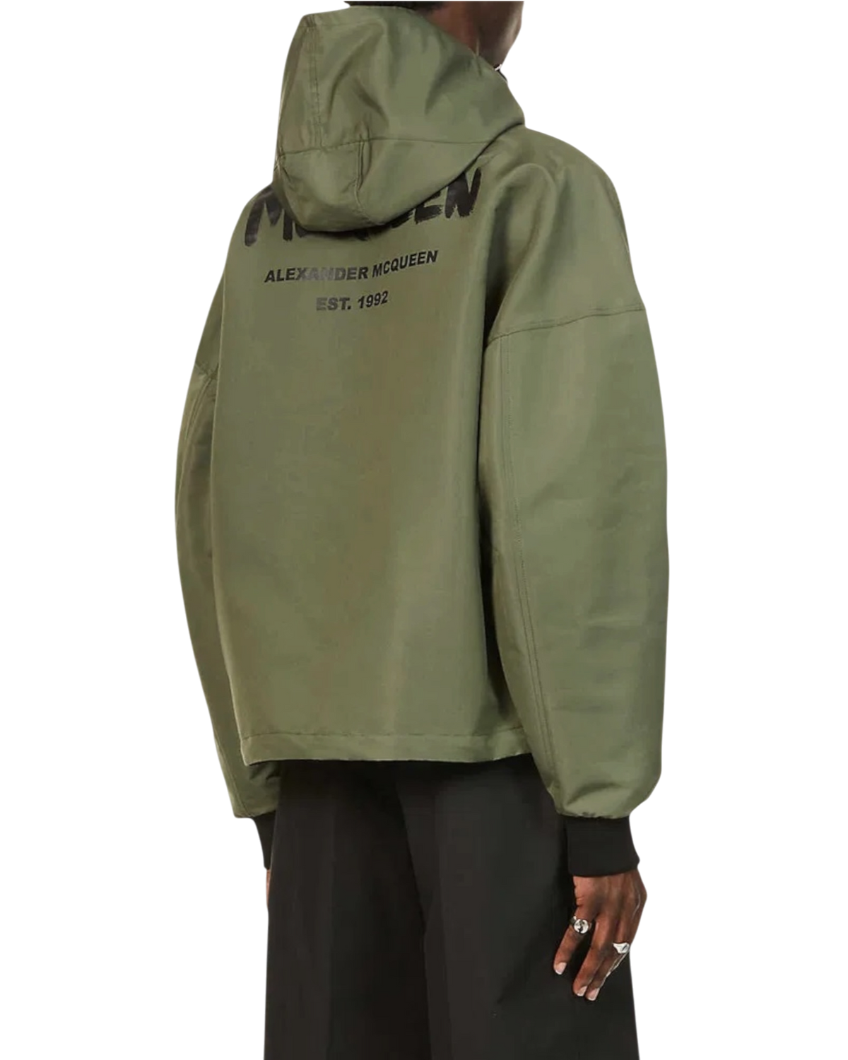 Alexander McQueen Graffiti logo nylon windbreaker in army green on model, angled back view with hood and logo