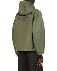 Alexander McQueen Graffiti logo nylon windbreaker in army green on model, angled back view with hood and logo