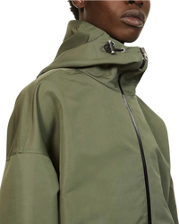 Alexander McQueen Graffiti logo nylon windbreaker in army green on model, close-up of the toggle hood and zip