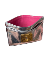 Schiaparelli Keyhole card holder in silver, angled front view open to show the hot pink leather lining and card slots