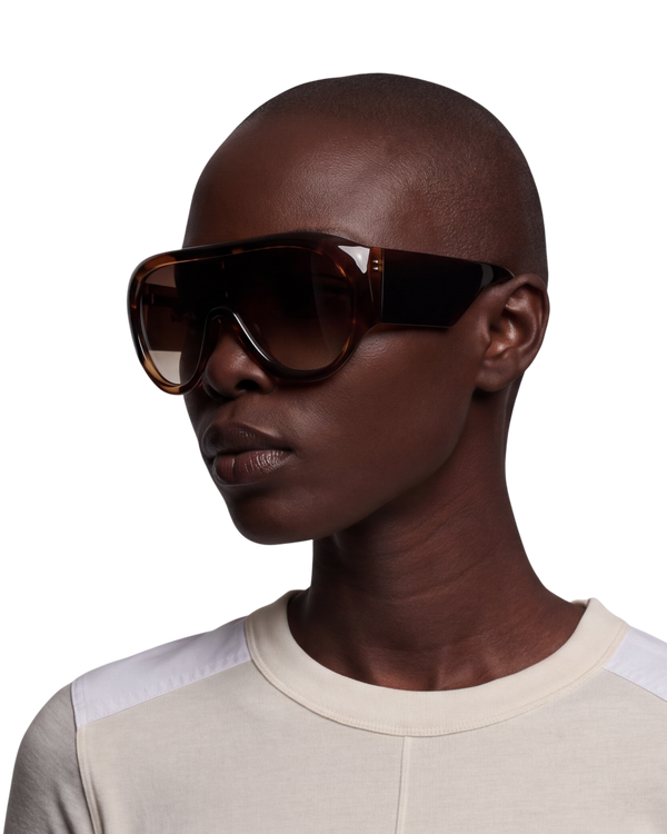 Phoebe Philo Bombé sunglasses in brown acetate on model, side angle of the oversized shield shape with gradient lens