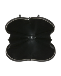 Alaïa Le Coeur leather shoulder bag in black, interior view unzipped flat to show the black lining and silver zip