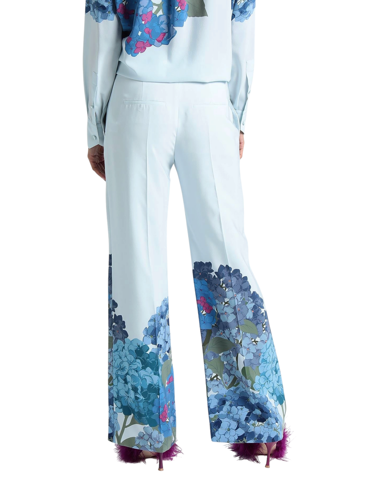 Valentino Garavani Macro Ortensia printed silk flared pants on model, back view of the pale blue flared legs