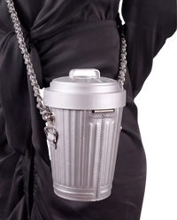 Moschino Trash Can chain shoulder bag in grey on model, worn crossbody on a chunky silver chain over a black dress