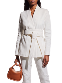 Gabriela Hearst Racer belted blazer in white on model, front view with shawl collar and wrapped quilted belt