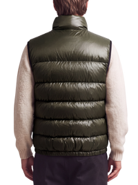Prada quilted ripstop down gilet in green, back view on model showing horizontal down channels and elasticated hem