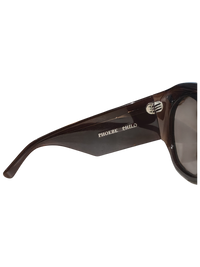 Phoebe Philo Bombé sunglasses in polished dark brown acetate with wide temples and gold logo branding.