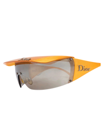 Dior Golf shield sunglasses in orange, angled view with visor attached, mirrored shield and silver Dior temple logo