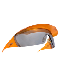 Dior Golf shield sunglasses in orange, side angle of the curved visor and orange temples with silver Dior lettering