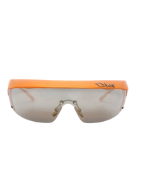 Dior Golf shield sunglasses in orange, front view of the flat orange visor brim over the mirrored shield lens