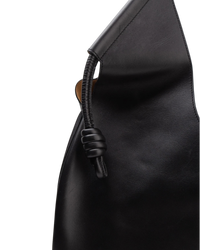Close detail of the Loewe Paseo tote's coiled leather knot where the handle meets the body
