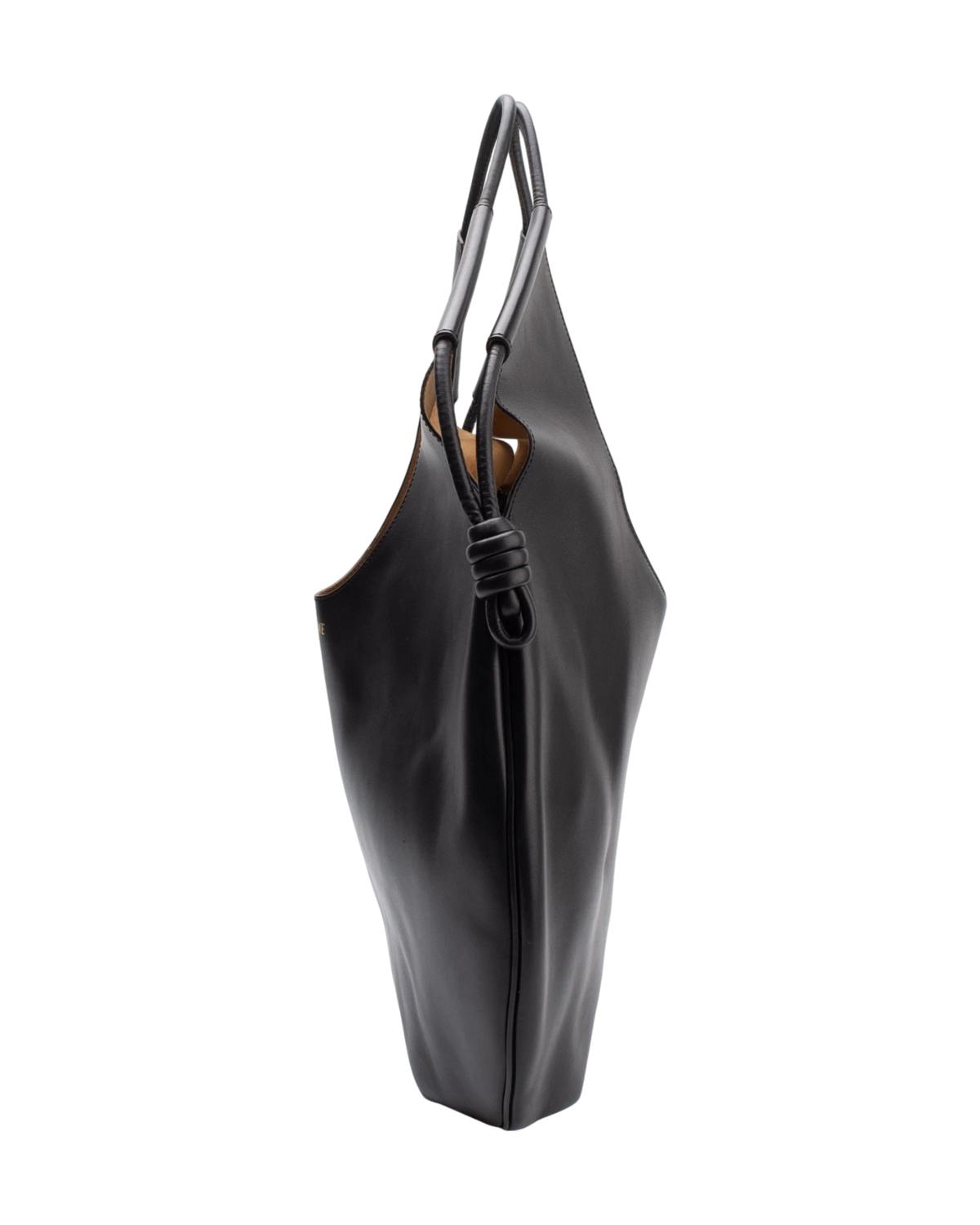 Side profile of the Loewe Paseo tote, showing the slim three-inch depth and the pleated body gathered by the knotted cord