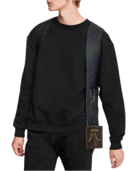 Louis Vuitton Cut Away Vest worn over a black crewneck, front view, showing the monogram embossed strap across the chest