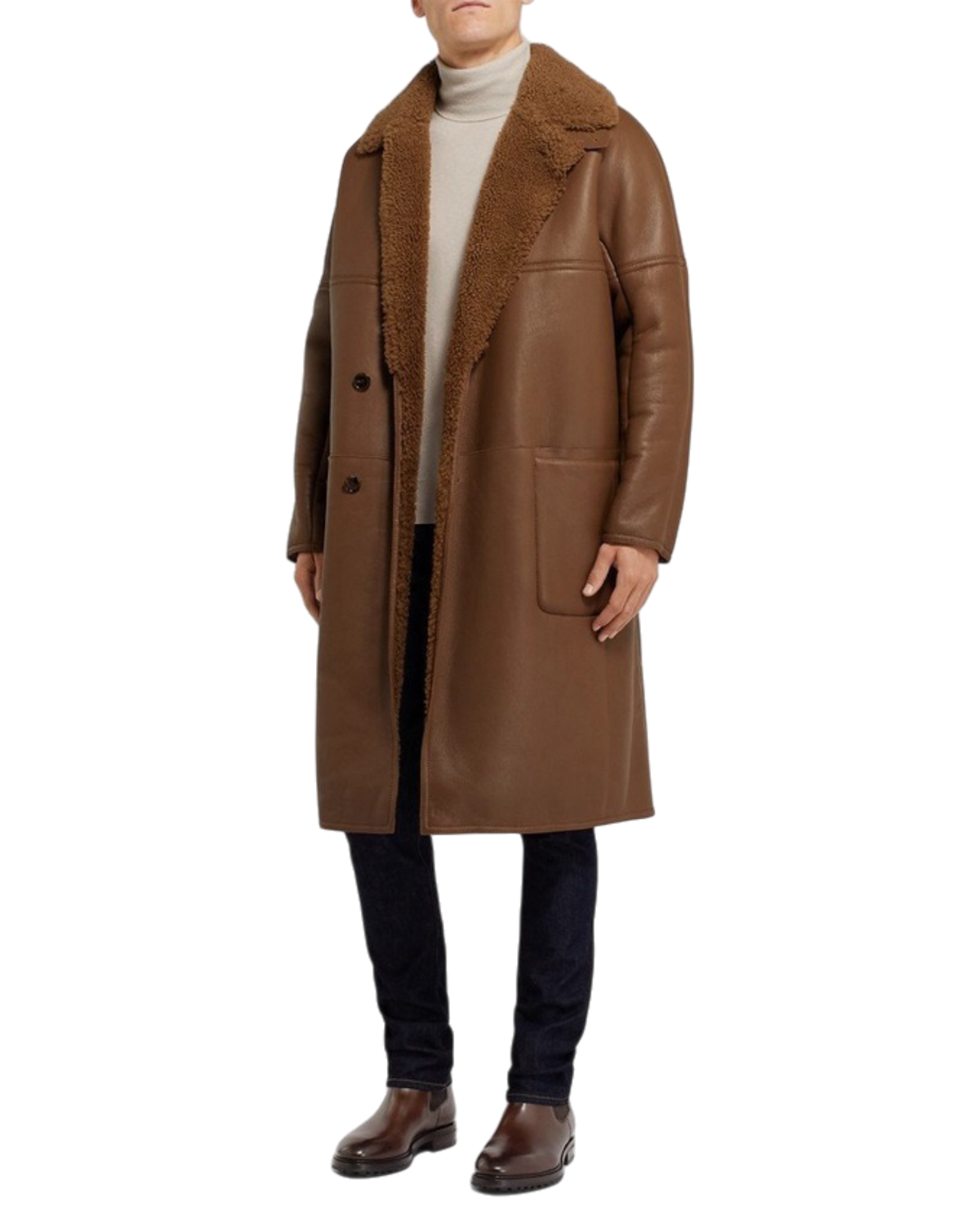 Full-length styling shot with the brown Chelsea boots worn under dark denim and a shearling coat
